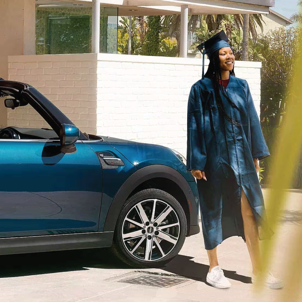 College graduate stepping out of her MINI