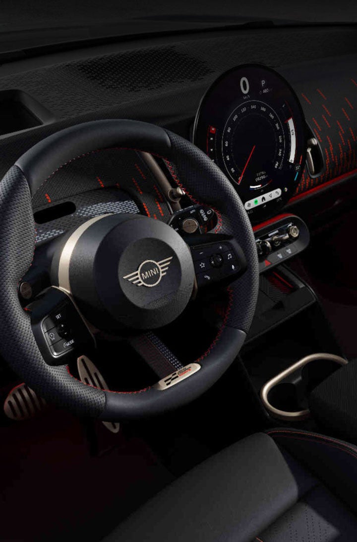 Overhead view of the front row and dashboard of a MINI JCW Countryman ALL4 from the perspective of the driver’s seat.