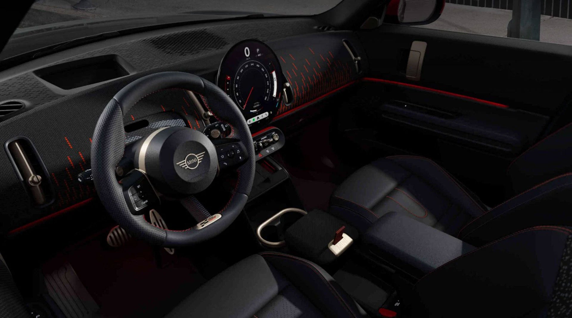 Overhead view of the front row and dashboard of a MINI JCW Countryman ALL4 from the perspective of the driver’s seat.