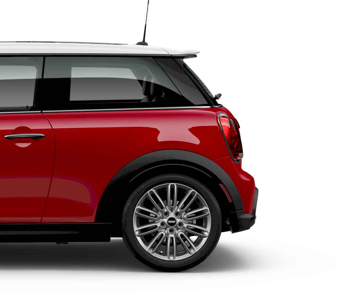 Side view of the rear of a red MINI Cooper 2 Door parked on a blank white surface with its shadow underneath it and nothing in the background.