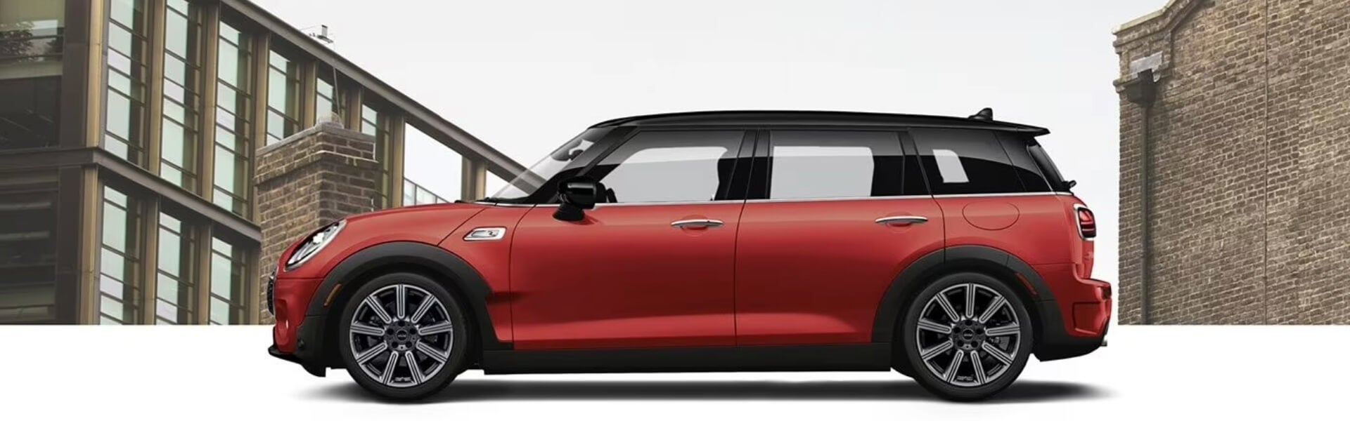 New MINI Clubman, With A Large Brick Building In The Background