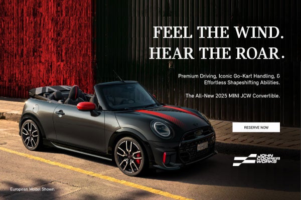 ¾ right view of a black MINI JCW convertible.