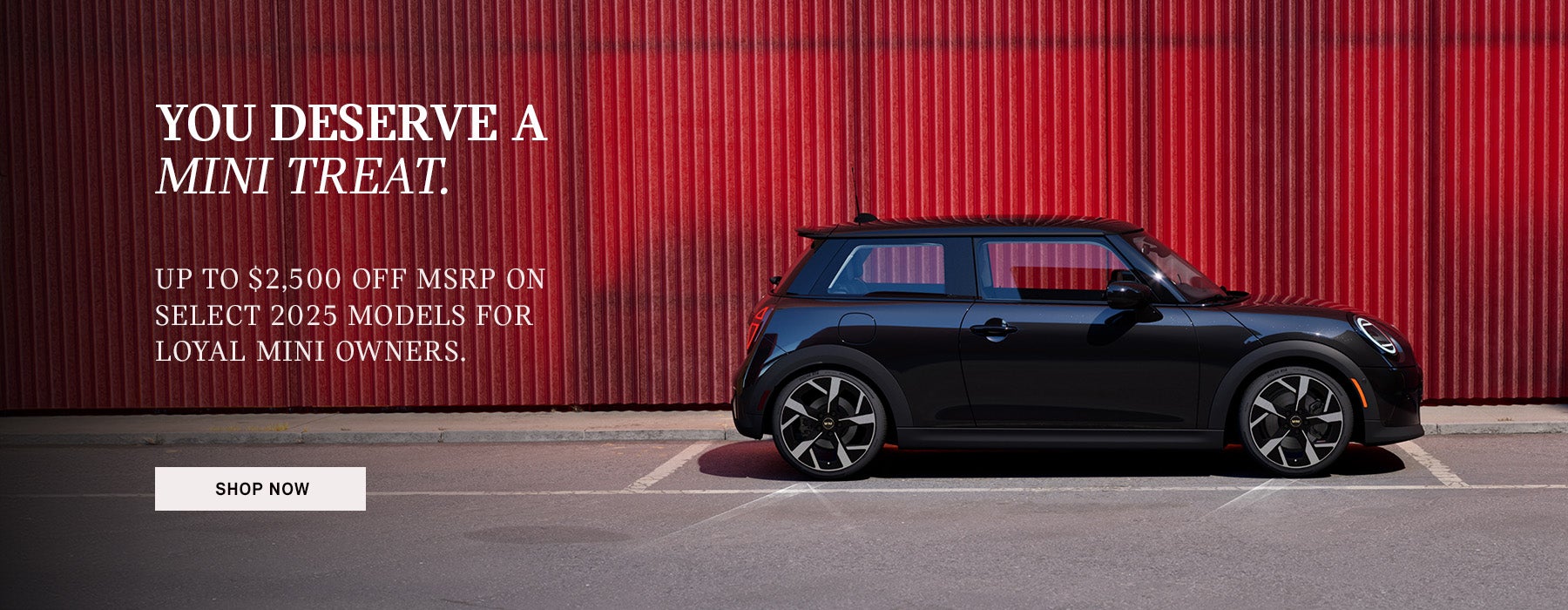 Side View of MINI vehicle parked infront of red wall