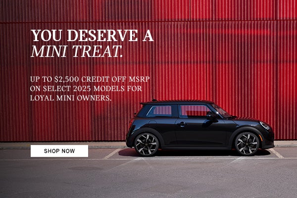 Side View of MINI vehicle parked infront of red wall